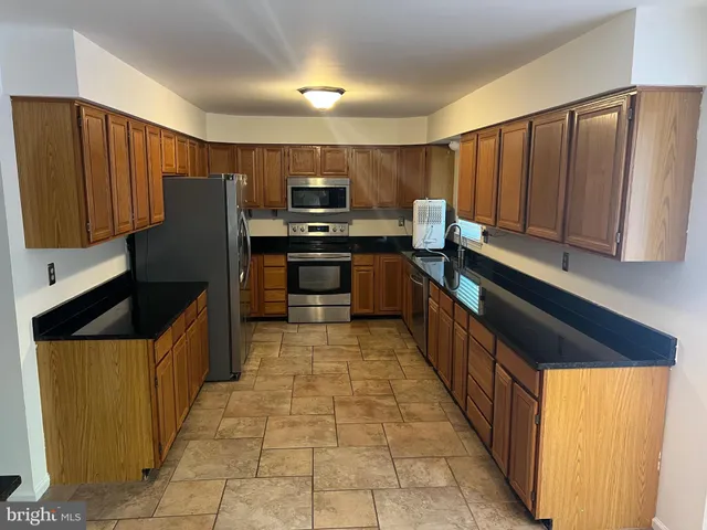a kitchen with stainless steel appliances a refrigerator and a stove