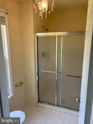 a view of staircase with wooden floor and white walls