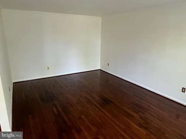 an empty room with wooden floor