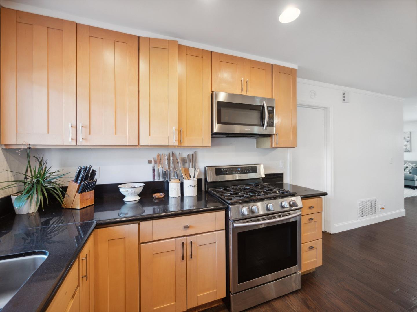 205 Evergreen Way Milpitas, CA 95035 - Photo 12 of 31 a kitchen with stainless steel appliances a stove a microwave and sink