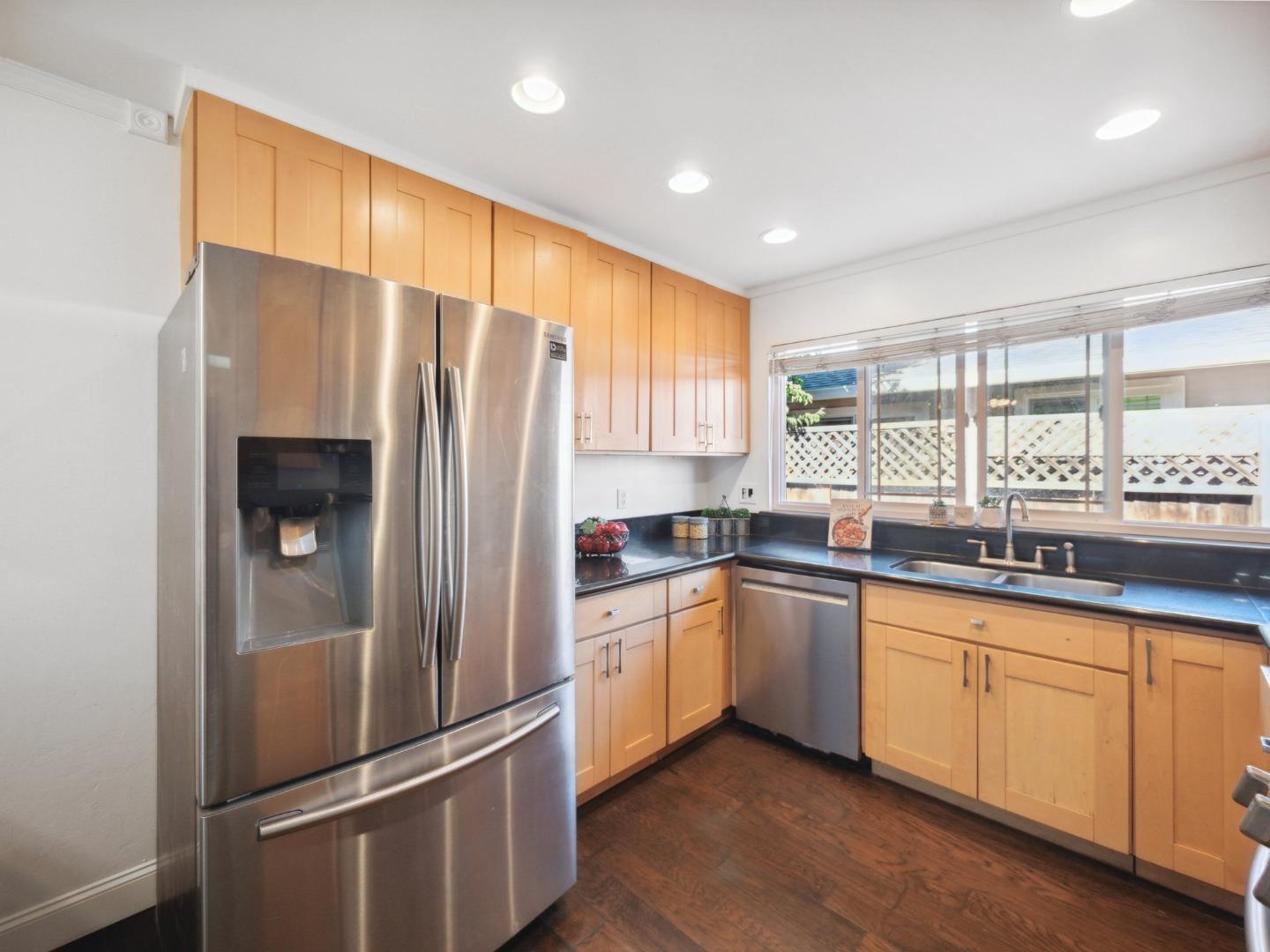 205 Evergreen Way Milpitas, CA 95035 - Photo 13 of 31 a kitchen with granite countertop stainless steel appliances a refrigerator sink and cabinets
