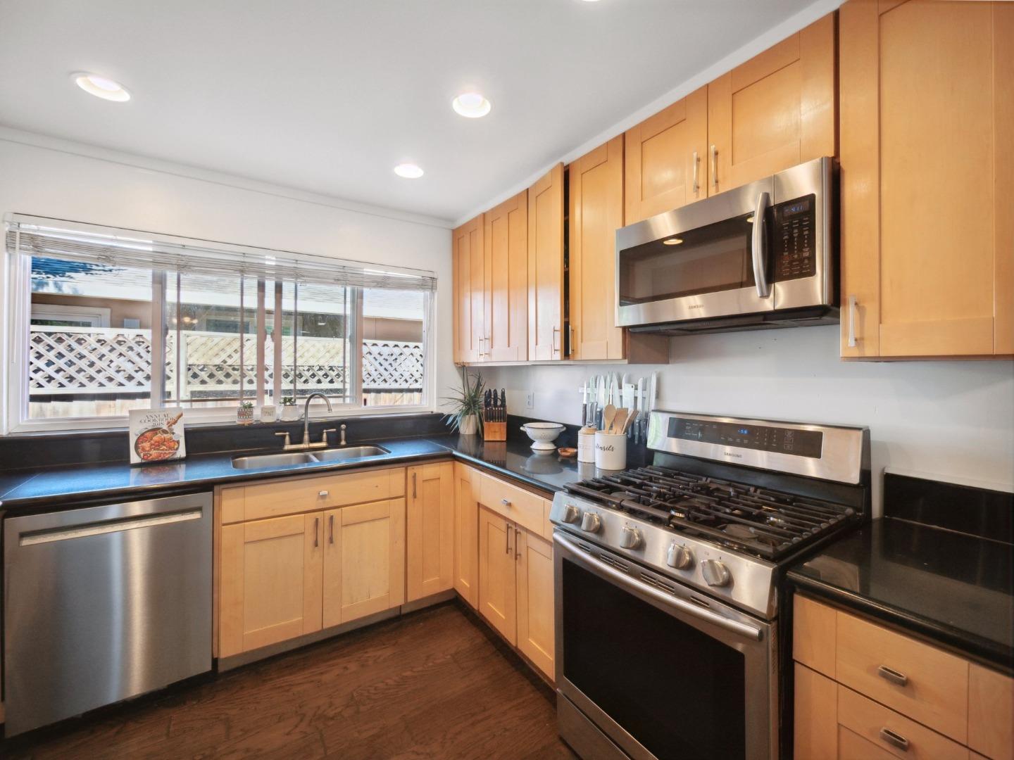 205 Evergreen Way Milpitas, CA 95035 - Photo 14 of 31 a kitchen with stainless steel appliances a sink stove and microwave