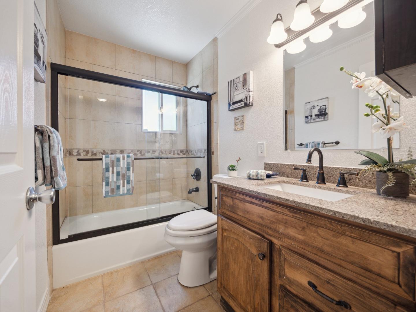 205 Evergreen Way Milpitas, CA 95035 - Photo 21 of 31 a spacious bathroom with a granite countertop sink a toilet a mirror and shower