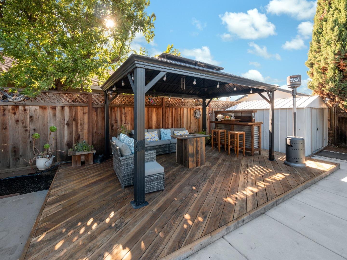 205 Evergreen Way Milpitas, CA 95035 - Photo 26 of 31 a view of a patio with table and chairs potted plants with wooden floor and fence