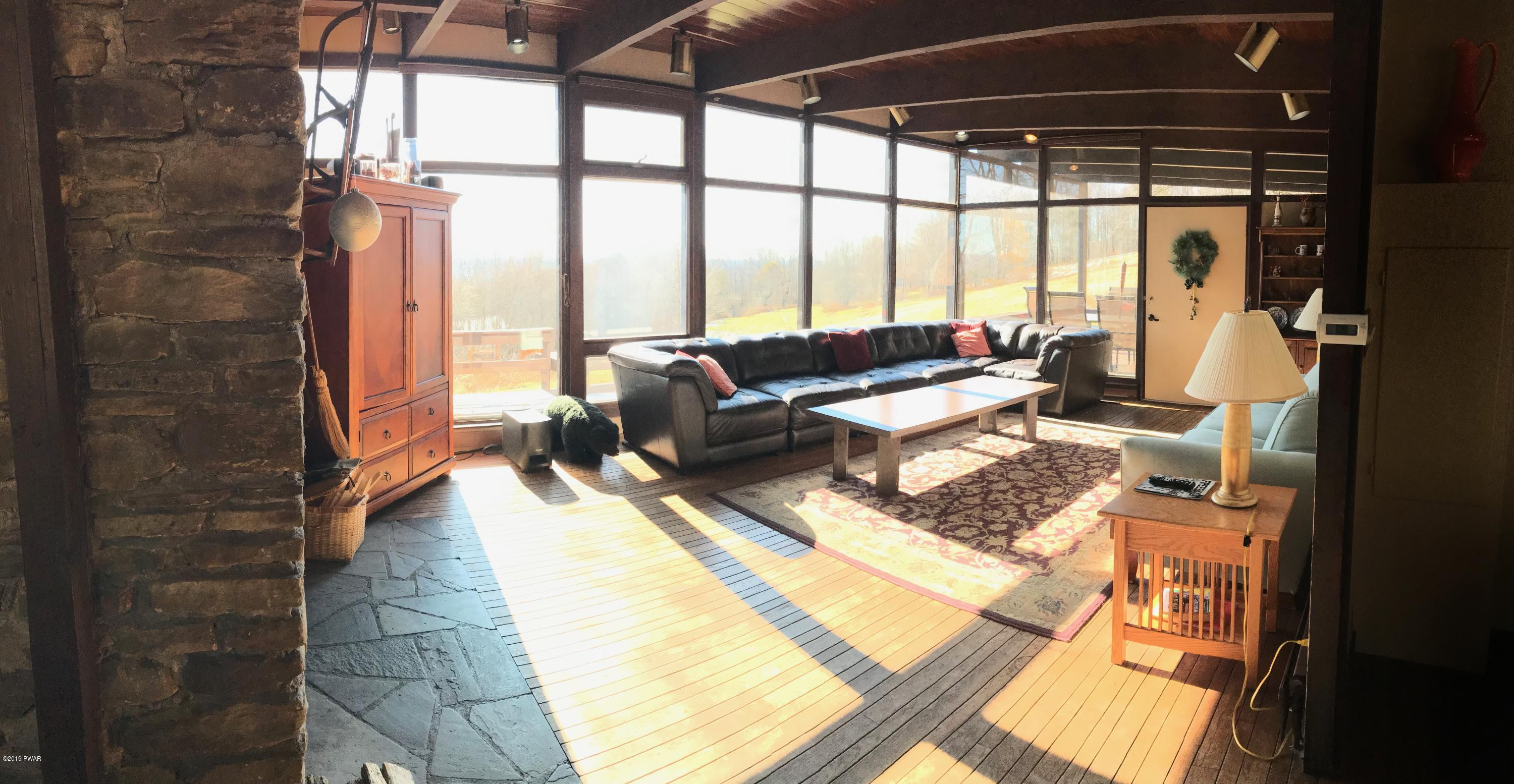819 Wargo Road Union Dale, PA 18470 - Photo 2 of 49 a living room with furniture and a floor to ceiling window