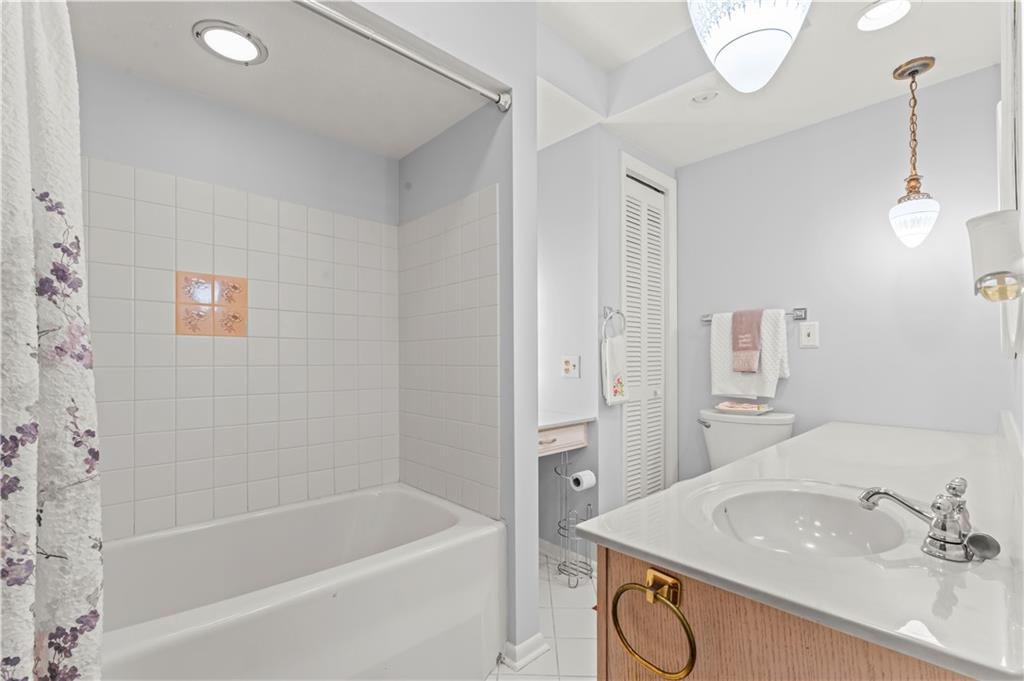 9 McElree Road Washington, PA 15301 - Photo 14 of 32 a bathroom with a sink a bathtub and a mirror