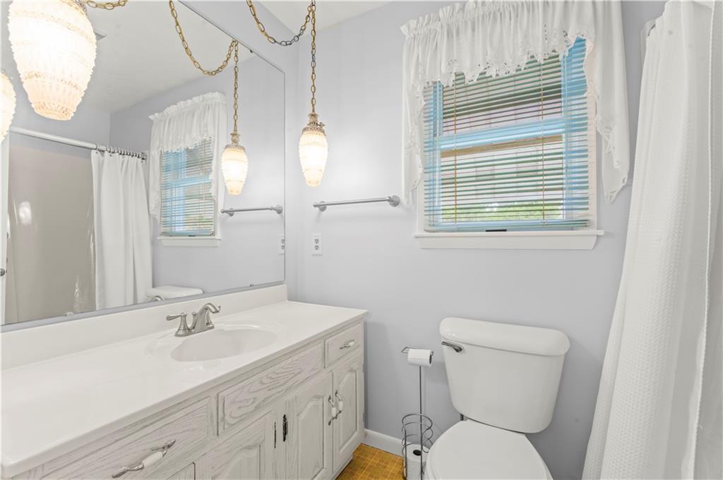 9 McElree Road Washington, PA 15301 - Photo 18 of 32 a bathroom with a toilet sink and mirror