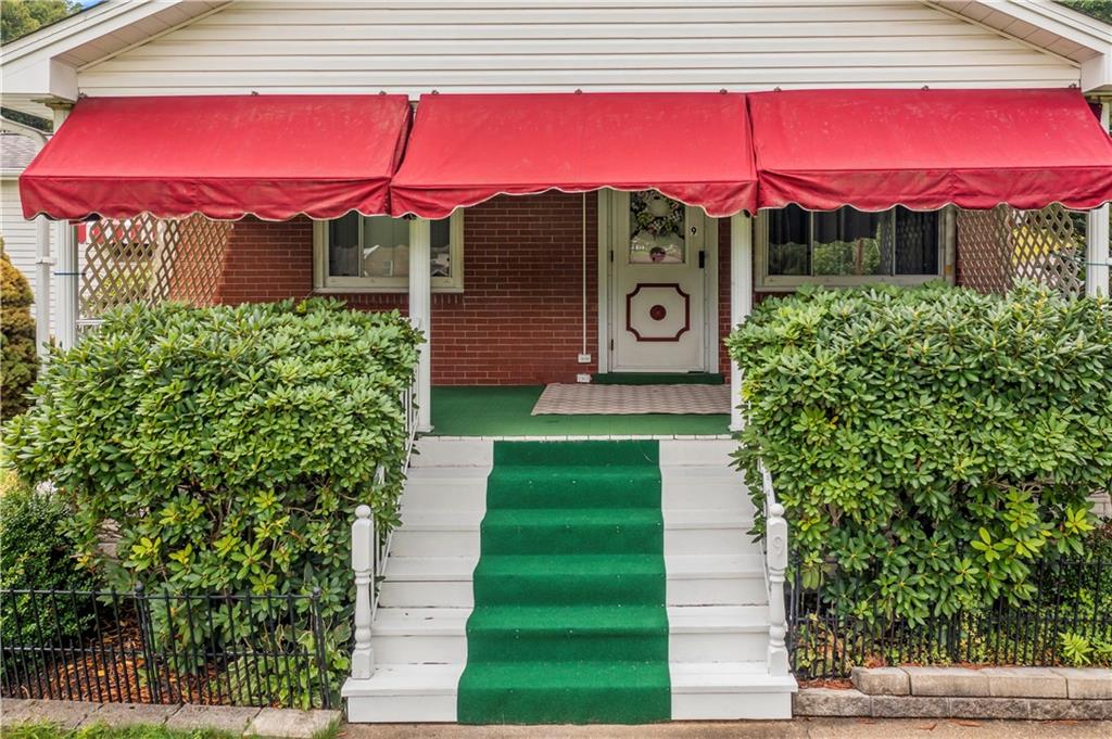 9 McElree Road Washington, PA 15301 - Photo 2 of 32 a view of a red and white house with a yard and potted plants