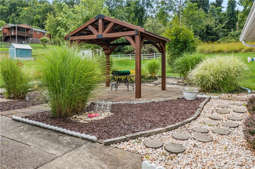 9 McElree Road Washington, PA 15301 - Photo 30 of 32 a view of a backyard with plants and a patio