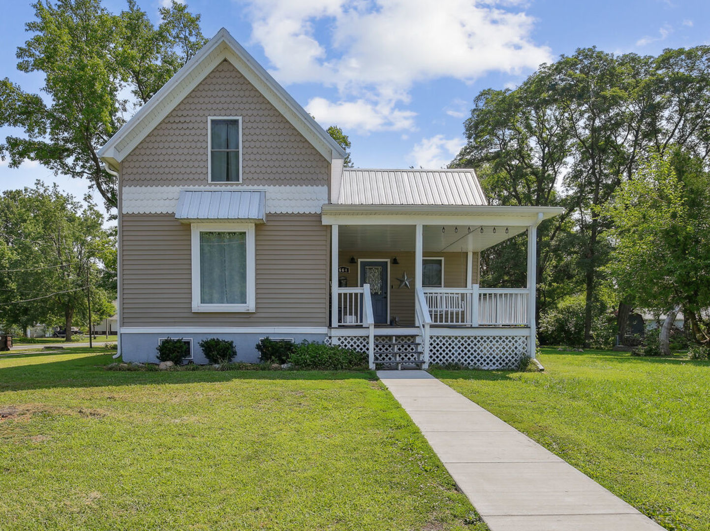 664 North Macon Street Bement, IL 61813 - Photo 1 of 24 a front view of a house with a yard