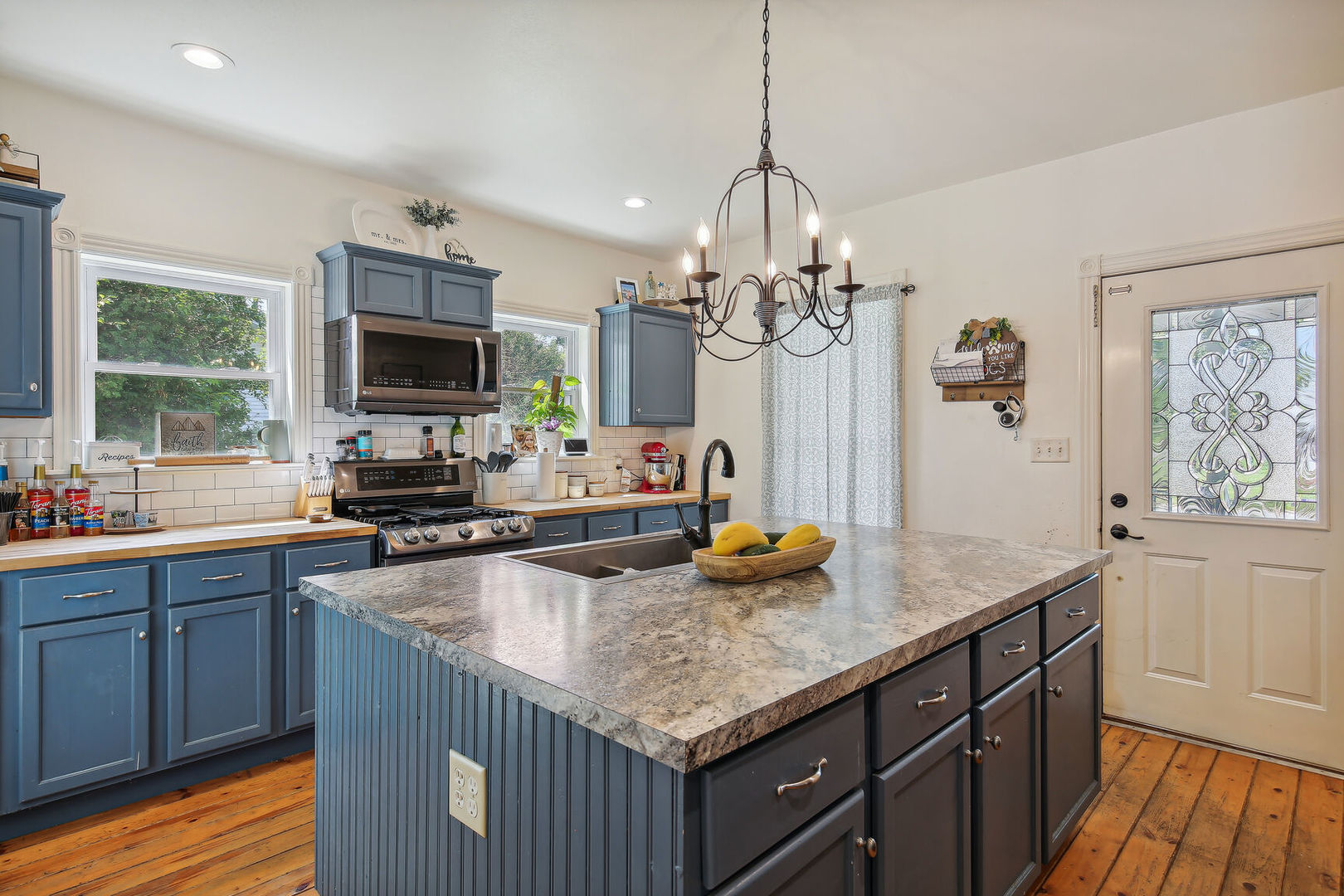 664 North Macon Street Bement, IL 61813 - Photo 8 of 24 a kitchen with sink a counter space and living room view
