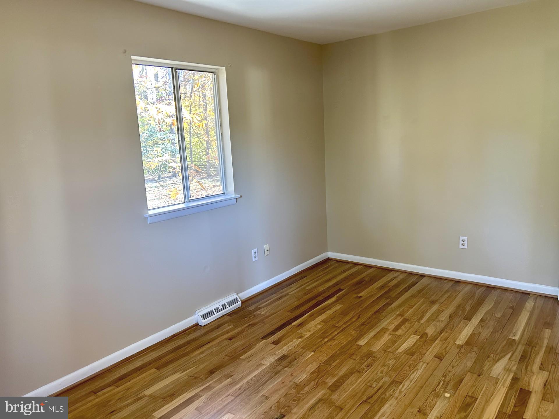 1527 Patuxent Manor Road Davidsonville, MD 21035 - Photo 13 of 36 a view of a room with wooden floor and a window