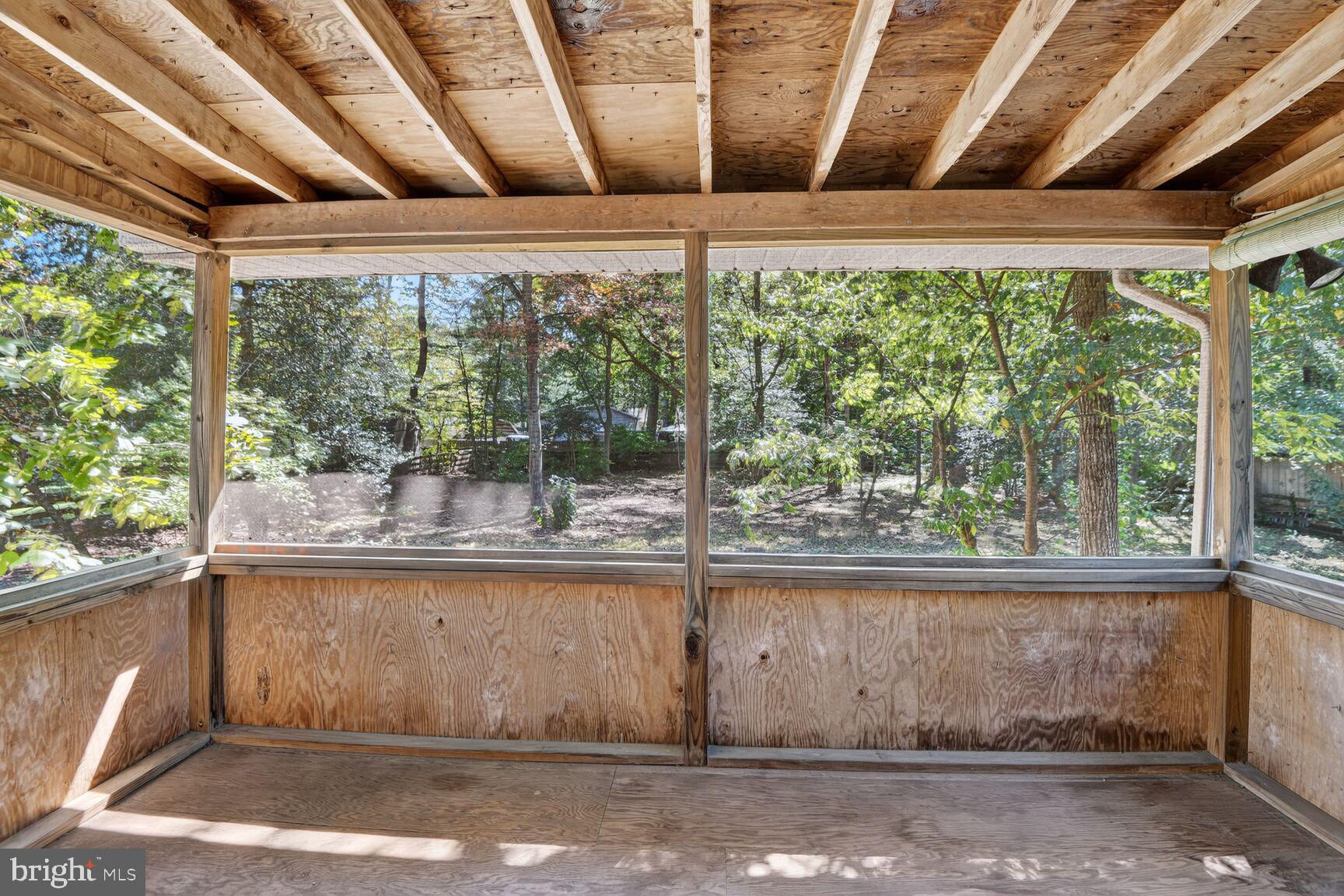 1527 Patuxent Manor Road Davidsonville, MD 21035 - Photo 15 of 36 a view of a room with a large window and wooden walls