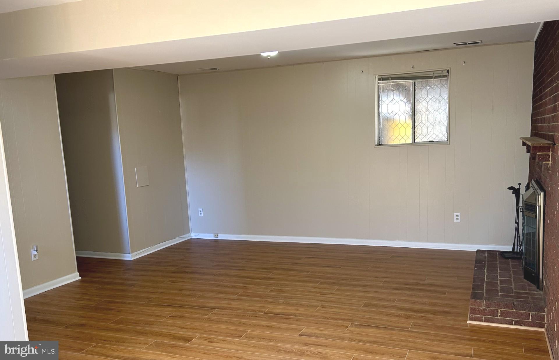 1527 Patuxent Manor Road Davidsonville, MD 21035 - Photo 21 of 36 a view of an empty room with wooden floor and a window