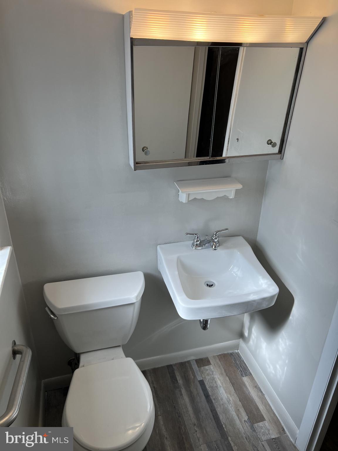 1527 Patuxent Manor Road Davidsonville, MD 21035 - Photo 22 of 36 a bathroom with a toilet sink and mirror