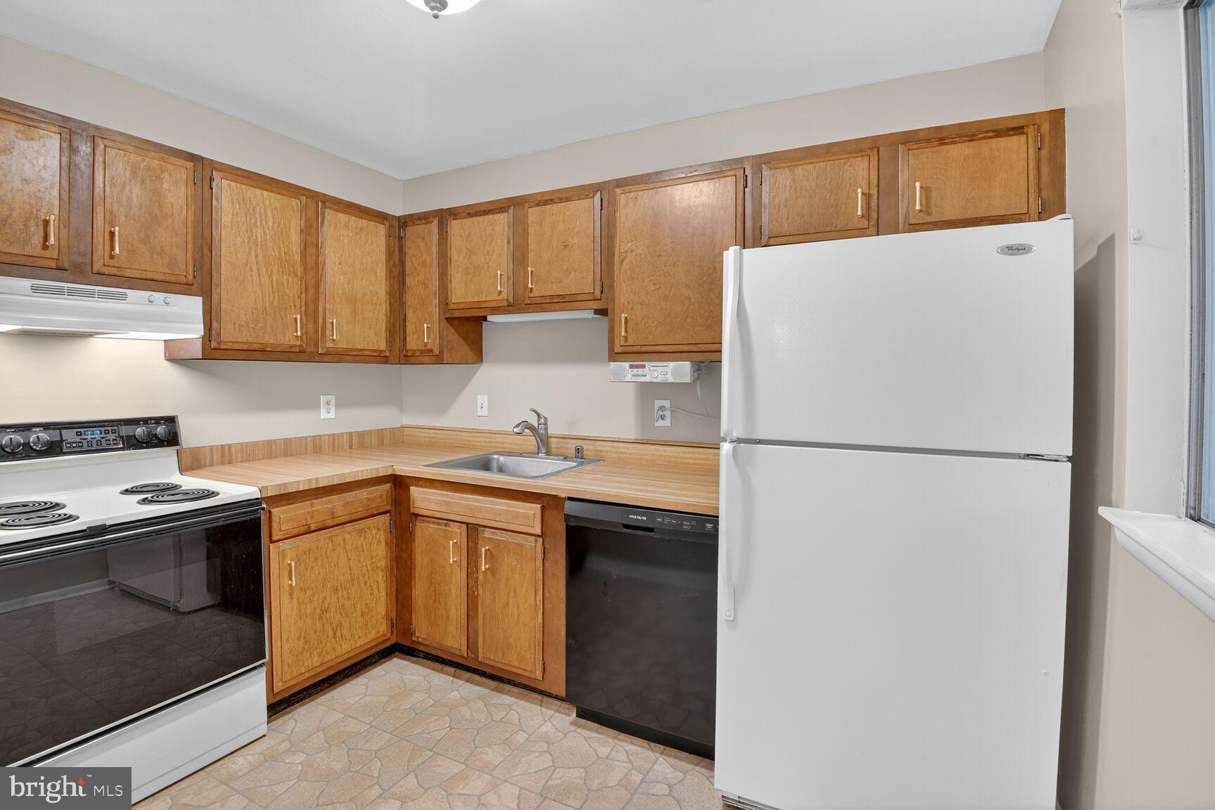 1527 Patuxent Manor Road Davidsonville, MD 21035 - Photo 6 of 36 a kitchen with a refrigerator sink and cabinets
