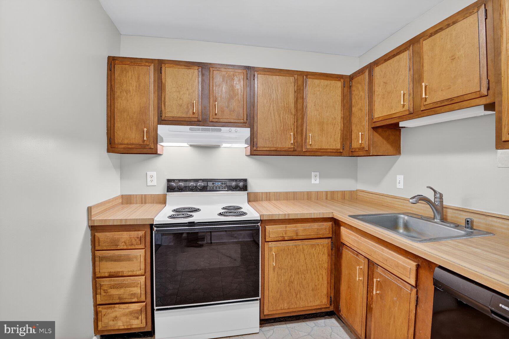 1527 Patuxent Manor Road Davidsonville, MD 21035 - Photo 7 of 36 a kitchen with a sink stove and cabinets