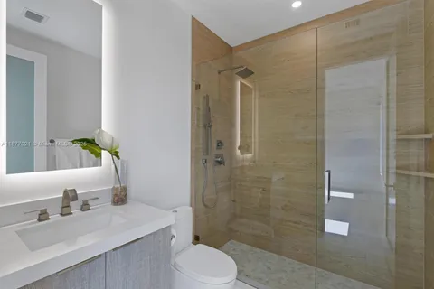 a bathroom with a sink toilet and shower