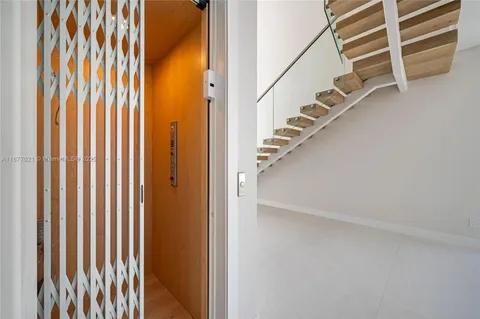 a view of staircase with railing and a window