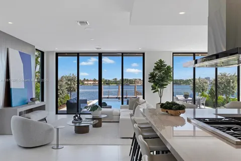 a living room with furniture and large windows