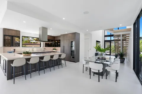 a large kitchen with a table and chairs