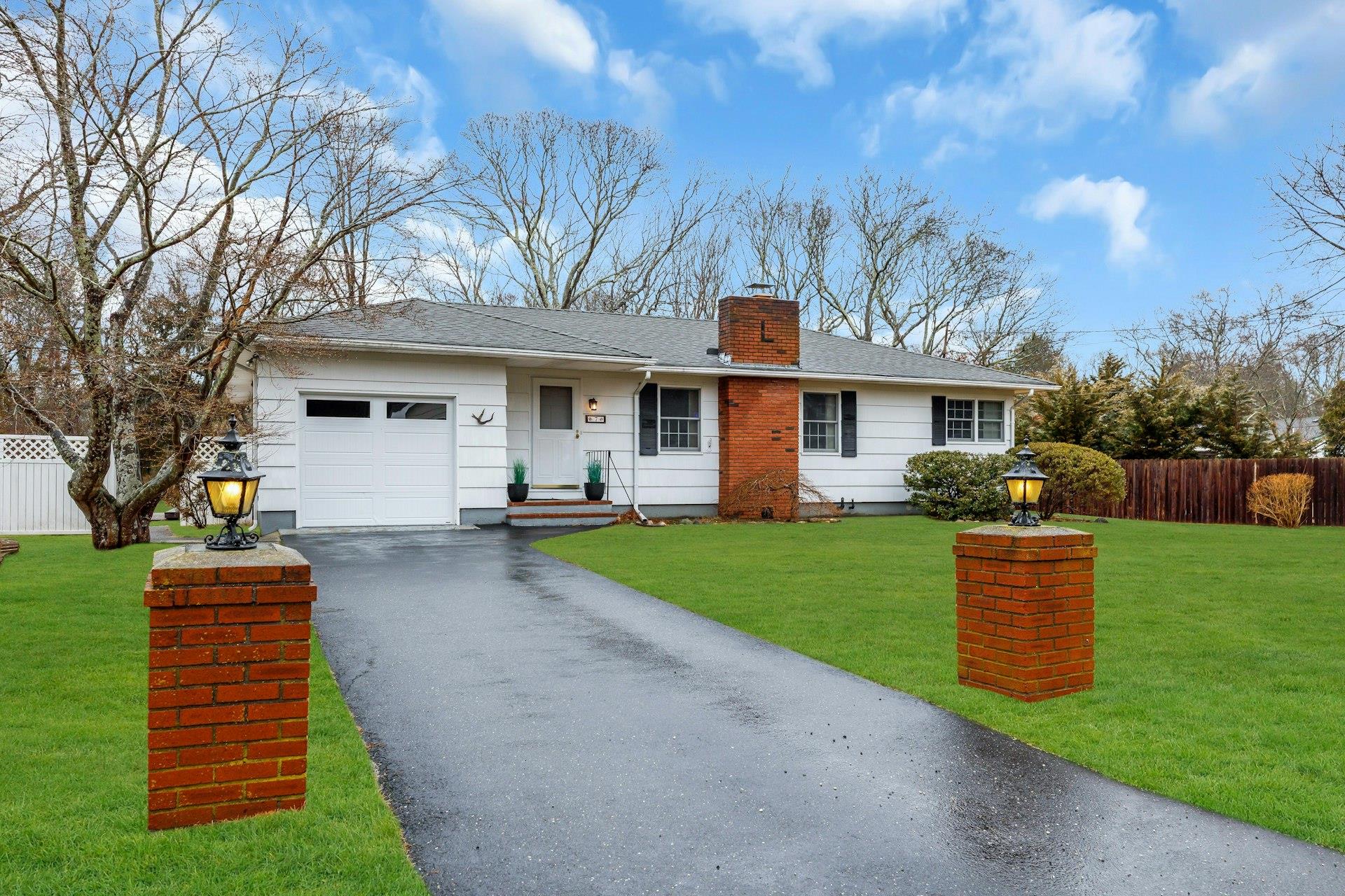7 Howell Place Speonk, NY 11972 - Photo 1 of 1 Ranch-style house with fence, a chimney, a front lawn, a garage, and aphalt driveway
