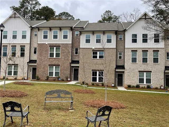 a backyard of a house with barbeque oven