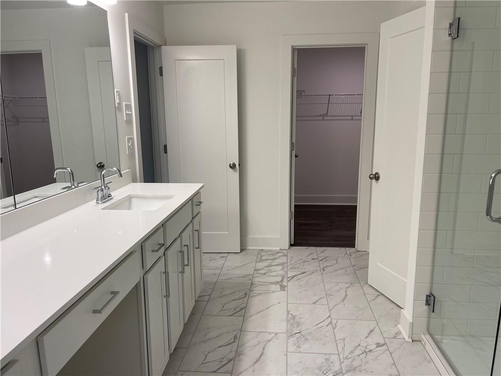 3391 Catalan Alley Avondale Estates, GA 30002 - Photo 12 of 18 a spacious bathroom with a mirror sink and shower