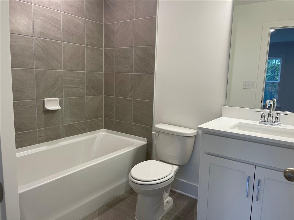 3391 Catalan Alley Avondale Estates, GA 30002 - Photo 13 of 18 a bathroom with a sink a toilet and bathtub