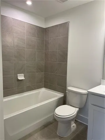 a bathroom with a toilet sink and shower