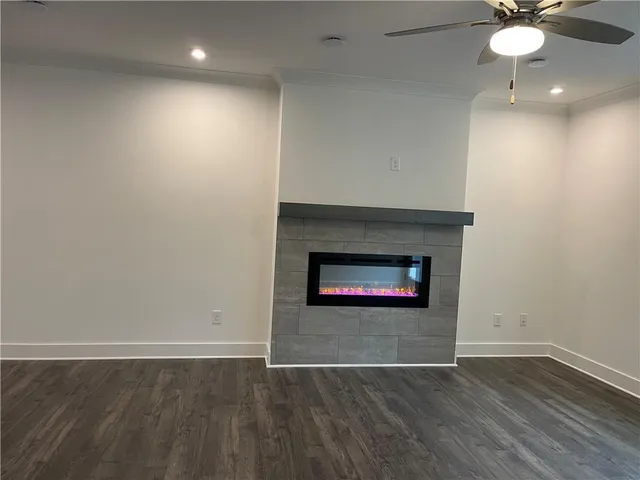 an empty room with wooden floor and a fireplace