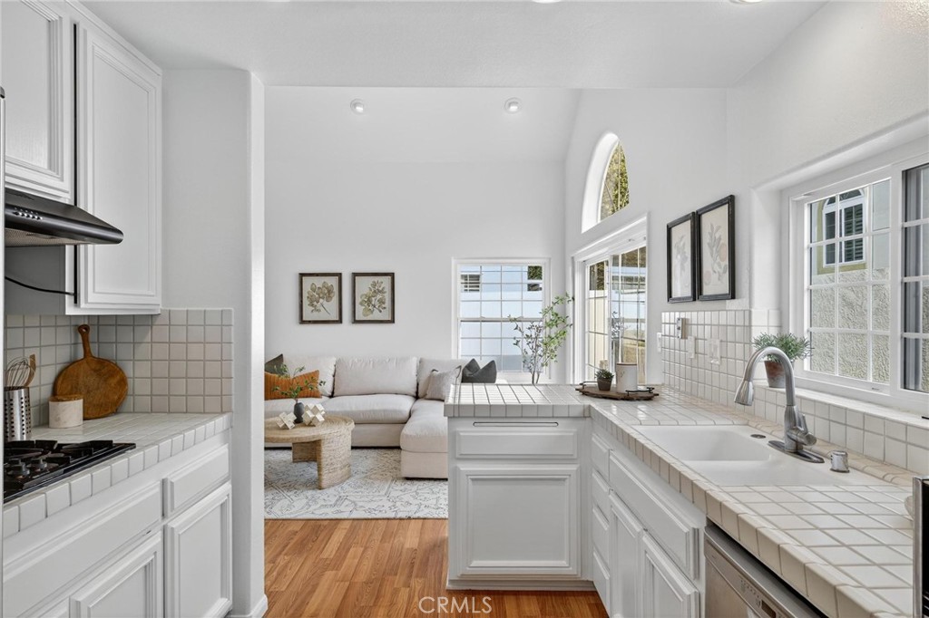1714 Flower Avenue Torrance, CA 90503 - Photo 12 of 40 a kitchen with a sink dishwasher and a stove with wooden floor