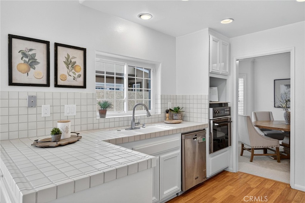 1714 Flower Avenue Torrance, CA 90503 - Photo 13 of 40 a kitchen with stainless steel appliances granite countertop a sink stove and cabinets