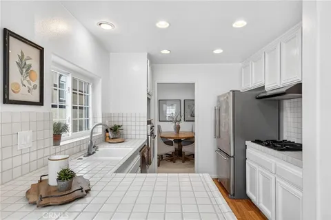 a kitchen with stainless steel appliances a refrigerator and a sink