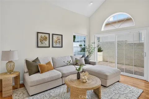 a living room with furniture and a potted plant