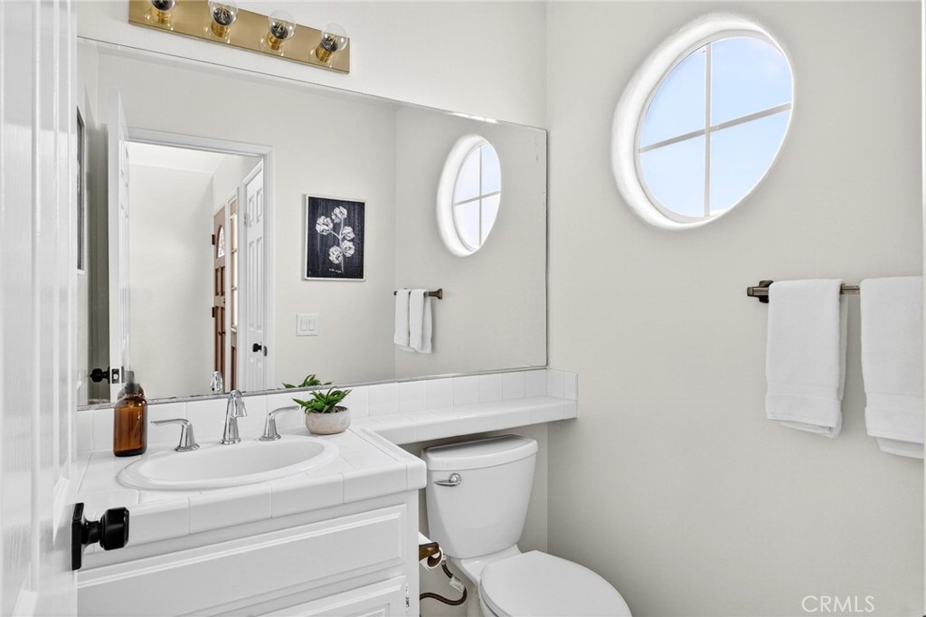 1714 Flower Avenue Torrance, CA 90503 - Photo 5 of 40 a bathroom with a toilet a sink and mirror