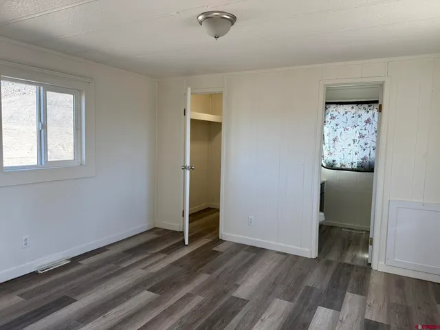 a bathroom with a granite countertop toilet sink and mirror