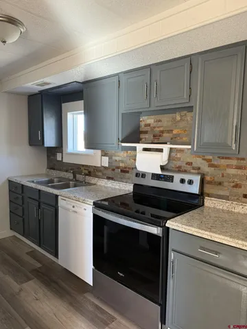 a kitchen with a sink stove and microwave