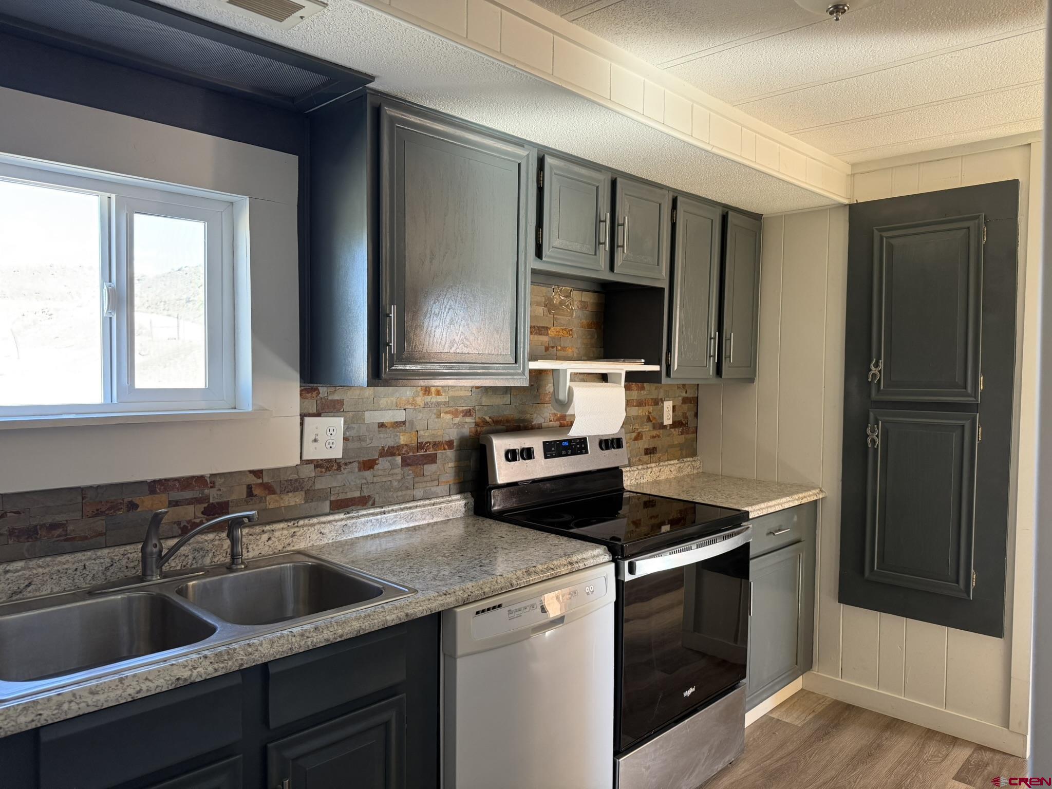 1205 Highway 50, Unit 24 Delta, CO 81416 - Photo 9 of 22 a kitchen with a sink stove and microwave