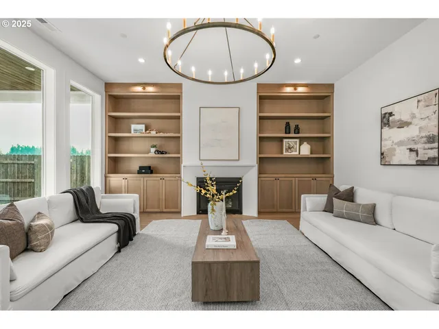 a living room with furniture a rug and white walls