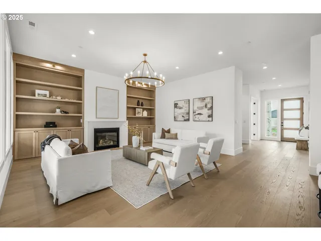 a living room with furniture a fireplace and a wooden floor
