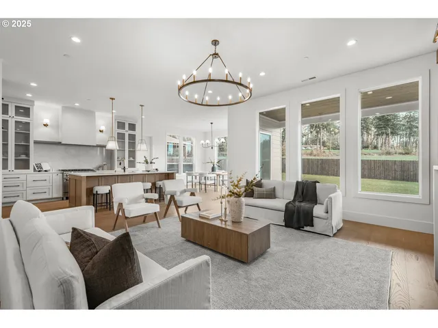 a living room with furniture and floor to ceiling windows