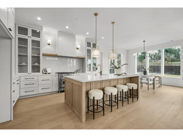 a large kitchen with cabinets table and chairs