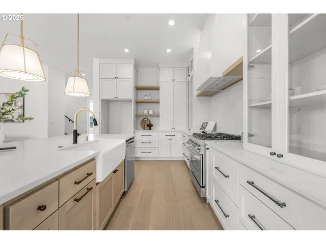 a large kitchen with kitchen island a sink stainless steel appliances and cabinets