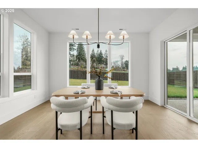 a view of a dining room with furniture a chandelier and wooden floor