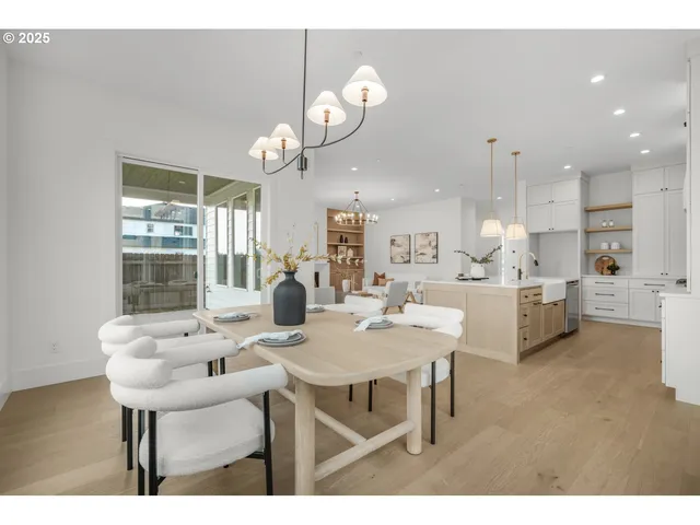 a view of kitchen with cabinets table and chairs