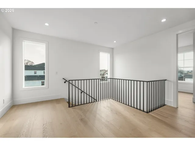 a view of a room with wooden floor