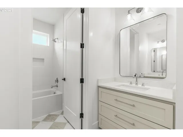 a bathroom with a sink a mirror and a bathtub