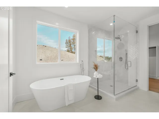 a bathroom with a white tub and shower