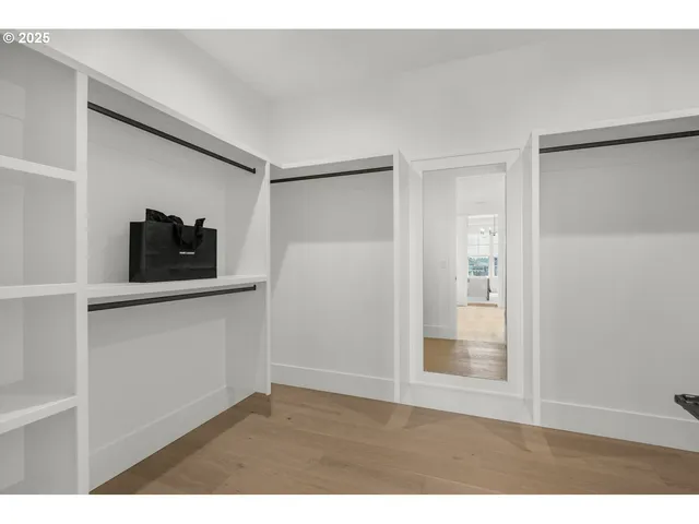 a living room with a flat screen tv and a refrigerator